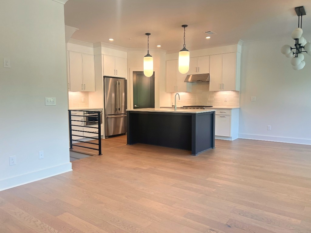 Open-concept kitchen and great room European white oak installation by CRG Flooring
